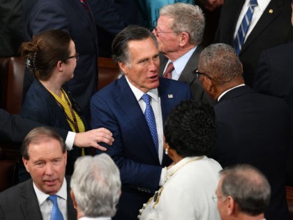 Senator from Utah Mitt Romney (C) greets other lawmakers ahead of US President Donald Trum