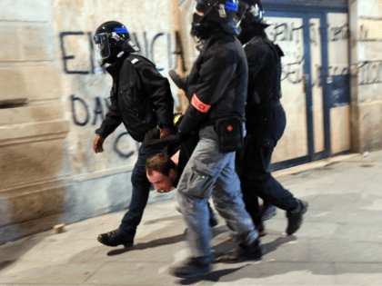 Policemen arrest a protester during an anti-government protest called by the yellow vests