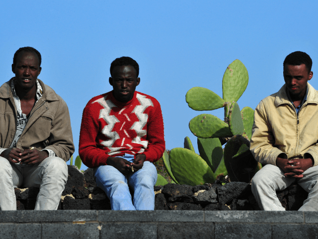 African migrants, who arrived the day before after fleeing Libya on March 28, 2011 rest near the port on the Italian tiny island of Linosa. Three boats laden with hundreds of African migrants, mostly Eritreans, Ethiopians and Somalians, fleeing Libya arrived in Italy, the first such vessels to reach Europe …