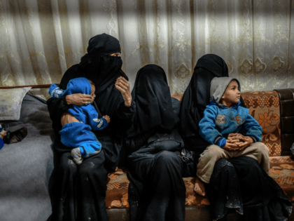 One of the two detained French women who fled the Islamic State group's last pocket in Syria sit with her children while speaking to a AFP reporter at al-Hol camp for displaced people in the al-Hasakeh governorate in northeastern Syria on February 17, 2019. - In the past two months, …