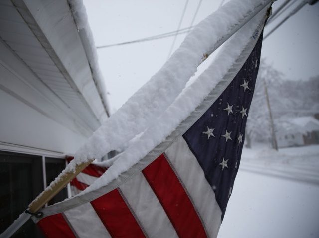 MANCHESTER, NH - FEBRUARY 05: Snow is seen gathered on an American flag during a snow storm as primary voters make up their minds on a Presidential candidate on February 5, 2016 in Manchester, New Hampshire. Democratic and Republican Presidential are stumping for votes throughout New Hampshire leading up to …