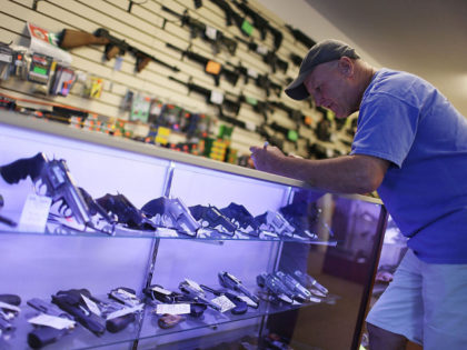Mark O'Connor fills out his Federal background check paperwork as he purchases a handgun at the K&W Gunworks store on the day that U.S. President Barack Obama in Washington, DC announced his executive action on guns on January 5, 2016 in Delray Beach, Florida.