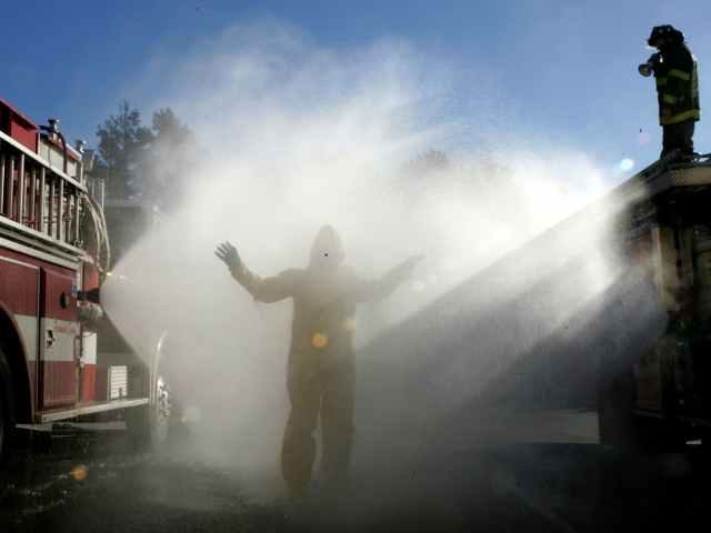 Hazmat team getting washed off by fire truck