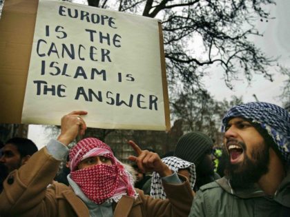 LONDON - FEBRUARY 03: Muslim demonstrators hold banners at the Danish Embassy on February