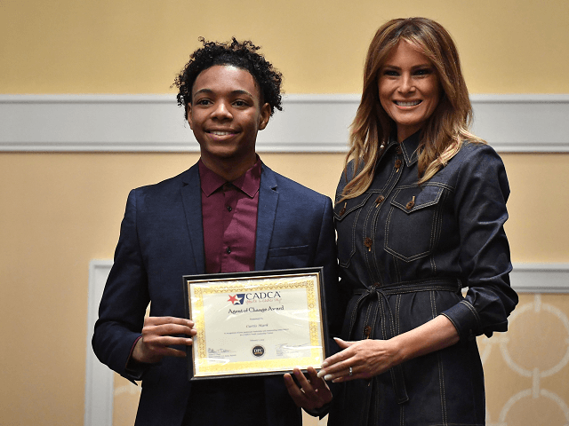 US First Lady Melania Trump presents an award to Curtis Mark during the Community Anti-Dru