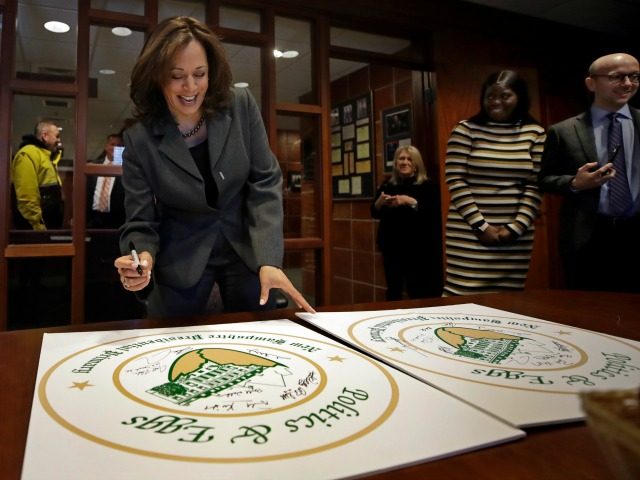 Democratic presidential candidate Sen. Kamala Harris, D-Calif., signs posters at a Politics & Eggs campaign event, Tuesday, Feb. 19, 2019, in Manchester, N.H. (AP Photo/Elise Amendola)