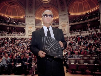 Karl Lagerfeld, the German fashion designer for Chanel, holds his fan as he enters the main auditorium at the Sorbonne, the oldest and most famous university in France, Oct. 18, 1994. Lagerfeld fielded questions from an audience of some 2,000 guests, including Sorbonne students on the Chanel fashion house. (AP …