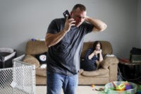 Tom Wolikow, Rochelle Carlisle In this Nov. 28, 2018 photo, Tom Wolikow, a General Motors employee who is currently laid-off, left, takes a phone call at home alongside his fiance Rochelle Carlisle, right, in Warren, Ohio. It was working-class voters who bucked the area's history as a Democratic stronghold and backed Donald Trump in …