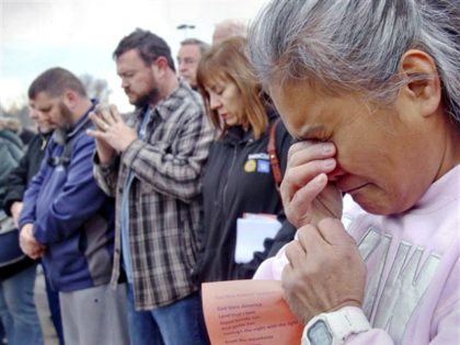 Venus Walker, of Warren, Ohio and a GM employee with 12 years at the Lordstown plant, prays during a vigil outside the Lordstown GM plant, on Nov. 29, 2018.
