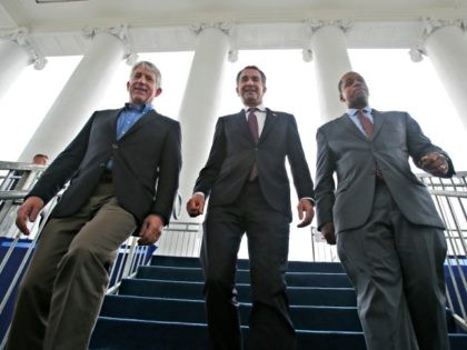 Virginia Gov.-elect, Lt. Gov Ralph Northam, center, walks down the reviewing stand with Lt. Gov-elect, Justin Fairfax, right, and Attorney General Mark Herring, as they participate in a walk through for their Saturday Inauguration at the Capitol in Richmond, Va., Friday, Jan. 12, 2018. (AP Photo/Steve Helber)