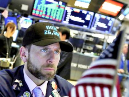 Specialist Michael Pistillo works on the floor of the New York Stock Exchange. Stocks are closing higher on Wall Street, sending the Dow Jones Industrial Average to its first close above 26,000 points. RICHARD DREW, AP