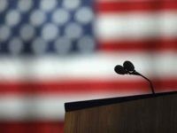 Microphones in front of a flag