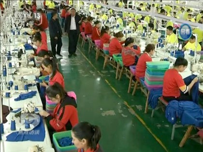 In this file image from undated video footage run by China's CCTV via AP Video, Muslim trainees work in a garment factory at the Hotan Vocational Education and Training Center in Hotan, Xinjiang, northwest China. A U.S. company that stocks college bookstores with t-shirts and other team apparel cut ties …