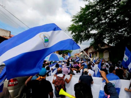 Anti-government protesters take part in a march dubbed 'United Nicaragua will never be defeated' in Granada, Nicaragua on August 25, 2018.