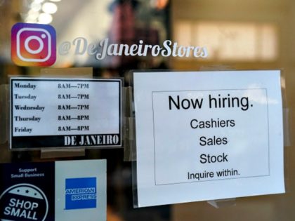 NEW YORK, NY - JANUARY 4: A 'now hiring' sign hangs on the door of a retail smal