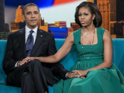 US President Barack Obama and US first lady Michelle Obama sit during a break in a taping