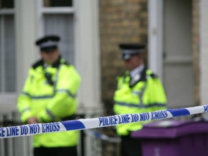 LIVERPOOL, UNITED KINGDOM - JULY 1: Police officers stand outside a house in Hatherley Street, after a raid searching for terror suspects on July 1, 2007 in Liverpool, England. Police launched raids on two properties in Liverpool and Glasgow after making a fifth arrest in connection with the national terrorism …