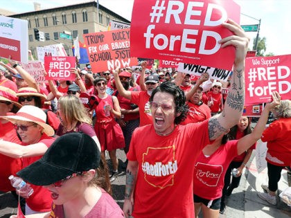 Thousands of Arizona teachers march through downtown Phoenix on their way to the State Capitol as part of a rally for the #REDforED movement on April 26, 2018 in Phoenix, Arizona. Teachers state-wide staged a walkout strike on Thursday in support of better wages and state funding for public schools. …