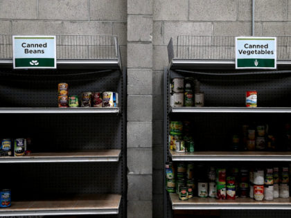 Shelves of canned foods sit partially empty at the SF-Marin Food Bank on May 1, 2014 in San Francisco, California.