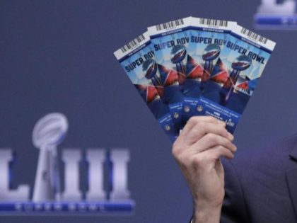 Michael, Buchwald, NFL Senior Counsel, Legal, holds up Super Bowl 53 tickets as he explain