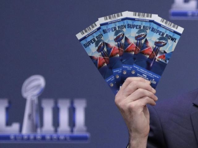 Michael, Buchwald, NFL Senior Counsel, Legal, holds up Super Bowl 53 tickets as he explain