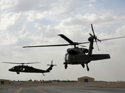 In this Monday, March 19, 2018 photo, UH-60 Black Hawk helicopters carrying U.S. and Afgha
