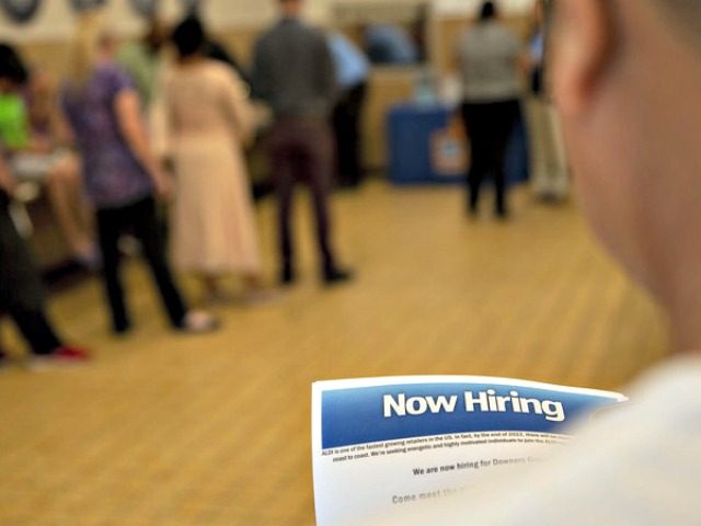The U.S. has added jobs in every month for nearly eight years. Here, a job seeker holds an employment flyer during a hiring event at an Aldi Supermarket in Darien, Ill., in July. Daniel Acker/Bloomberg via Getty Images
