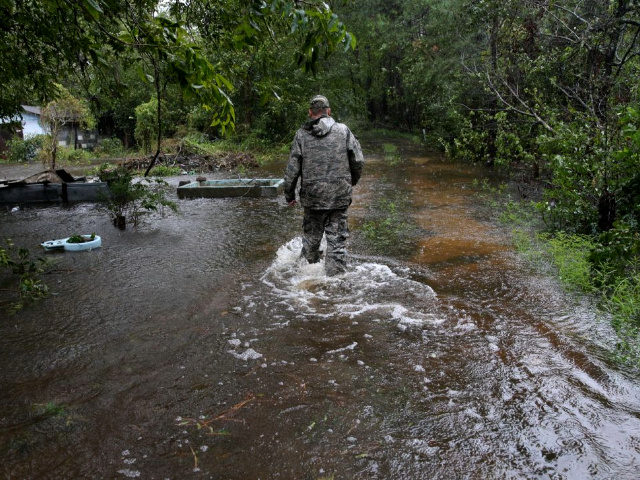 A member of the Cajun Navy resue team walks in flooded waters in Lumberton, North Carolina
