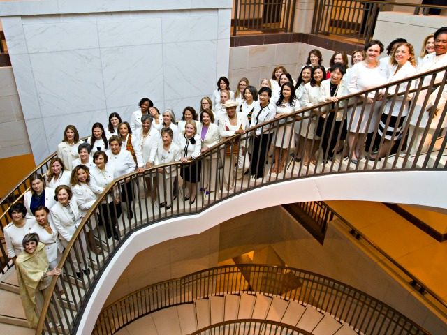 House Speaker Nancy Pelosi of Calif., center, is joined by other women wearing white, as t