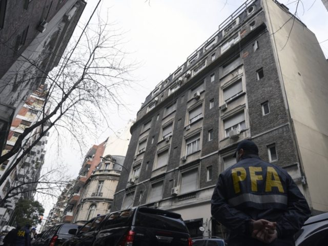 An Argentina's Federal police officer stands guard on the street in front of a building wh