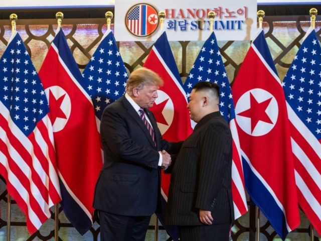 US President Donald Trump (L) shakes hands with North Korea's leader Kim Jong Un before a