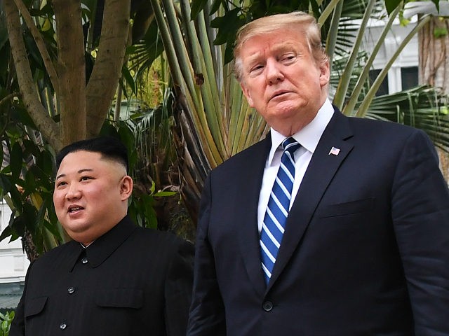 US President Donald Trump (R) walks with North Korea's leader Kim Jong Un during a break i