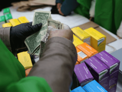 NEW YORK, NY - FEBRUARY 08: MOney is collected as Girl Scouts sell cookies while a winter