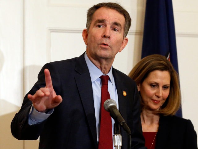 Virginia Gov. Ralph Northam, left, gestures as his wife, Pam, listens during a news confer