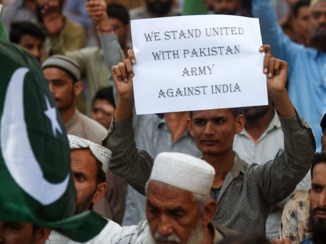 A Pakistani supporter of Sunni Tehreek (ST) holds a placard during an anti-Indian protest