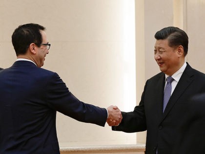 US Treasury Secretary Steven Mnuchin shakes hands with Chinese President Xi Jinping (2nd R) as US Trade Representative Robert Lighthizer (L) and Chinese Vice Premier Liu He (R) look on before proceeding to their meeting at the Great Hall of the People in Beijing on February 15, 2019. (Photo by …