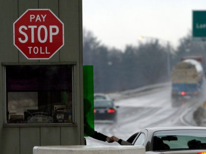 A turnpike worker collects a toll at a toll booth off the Ohio Turnpike Tuesday, Jan. 11, 2005 in North Ridgeville, Ohio. Ohio turnpike workers are negotiating a contract following a weeklong strike by Pennsylvania turnpike workers that failed to disrupt toll collections. (AP Photo/Tony Dejak)