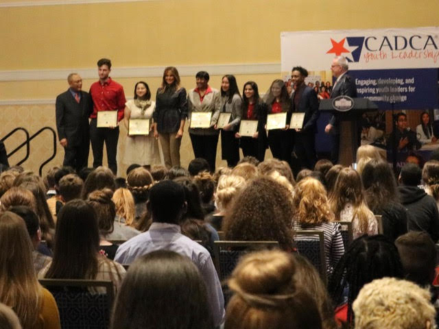 First Lady Melania Trump stands with award winners at a conference of the Community Anti-Drug Coalition (CADCA) in National Harbor, Maryland. (Michelle Moons/Breitbart News)