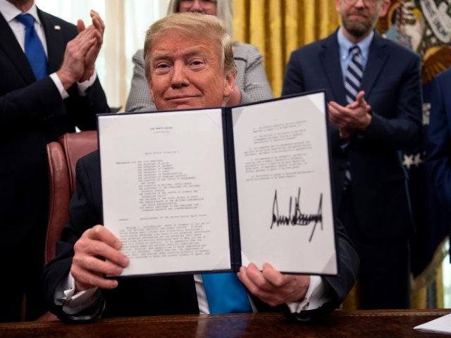 US President Donald Trump shows his signature on the Space Policy Directive-4 (SPD-4) on F