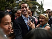 Venezuelan opposition leader and self declared acting president Juan Guaido greets supporters at a demonstration called by supporters in the transportation sector, in Caracas on February 20, 2019 Maduro shuts border with Brazil as Guaido goes in search of aid