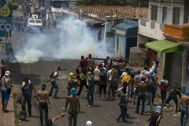 Venezuela Political Crisis Demonstrators clash with the Bolivarian National Guard in Urena, Venezuela, near the border with Colombia, Saturday, Feb. 23, 2019. Venezuela's National Guard fired tear gas on residents clearing a barricaded border bridge between Venezuela and Colombia on Saturday, heightening tensions over blocked humanitarian aid that opposition leader Juan Guaido has vowed to bring into the country over objections from President Nicolas Maduro. (AP Photo/Rodrigo Abd) The Associated Press