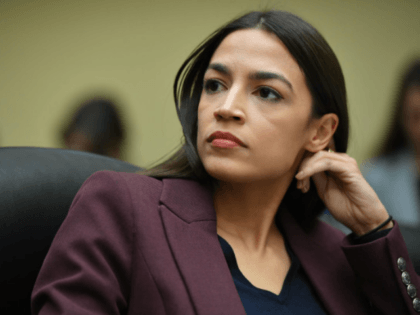 Rep. Alexandria Ocasio-Cortez (D-NY) listens to testimony by Michael Cohen, former attorne