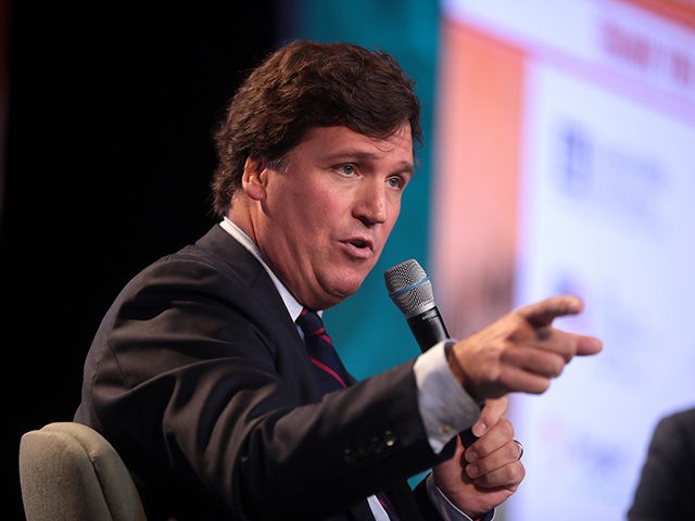 Tucker Carlson speaking with attendees at the 2018 Student Action Summit hosted by Turning