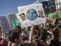 A student holds a banner showing images of U.S. President Donald Trump, right, and Brazil President Jair Bolsonaro during a pro-environment protest in Madrid, Spain, Friday March 15, 2019. Students mobilized by word of mouth and social media skipped class Friday to protest what they believe are their governments' failure …