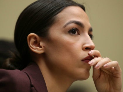 Rep. Alexandria Ocasio-Cortez (D-NY) listens to testimony by Michael Cohen, former attorne