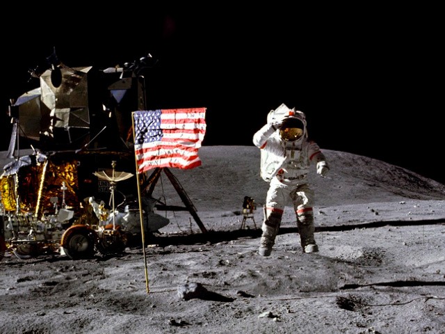 In this April 1972 photo made available by NASA, John Young salutes the U.S. flag at the Descartes landing site on the moon during the first Apollo 16 extravehicular activity. NASA says the astronaut, who walked on the moon and later commanded the first space shuttle flight, died on Friday, Jan. 5, 2018. He was 87.