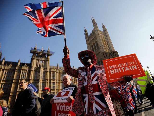 TOPSHOT - Pro-Brexit activists march outside the Houses of Parliament in central London on