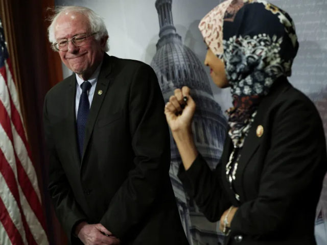 U.S. Rep. Ilhan Omar (D-MN) (R) and Sen. Bernie Sanders (I-VT) (L) share a moment during a