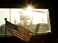 Border guard A border guard stands on Iraq's border with Kuwait behind a US flag fluttering on the dashboard of a Mine Resistant Ambush Protected (MRAP) vehicle from the 3rd Brigade Combat Team, 1st Cavalry Division as the last US convoy leaves Iraq on December 18, 2011.