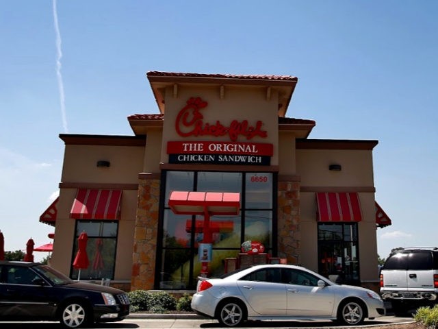 Drive through customers wait in line at a Chick-fil-A restaurant on August 1, 2012 in Fort